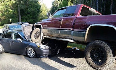 Two Vancouver Island men are in custody after two police vehicles were destroyed by a Dodge pickup that drove over the cars as the officers approached.