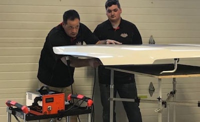 Domenic Serra, owner of PDR Canada, demonstrates the electronic dent repair machine.