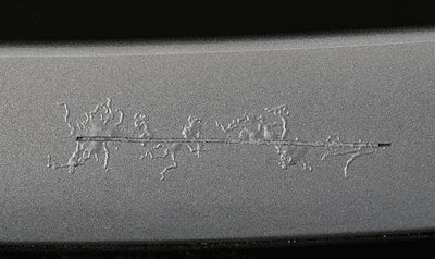 Filiform corrosion spreading from scribe on painted aluminum.