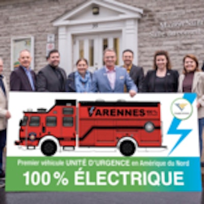 Firefighters_and_city_officials_with_the_City_of_Varennes_pose_with_a_preliminary_drawing_of_E-ONE_Vector_electric_rescue_vehicle