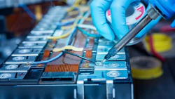 Technician use soldering iron to solder metal and wire of lithiu