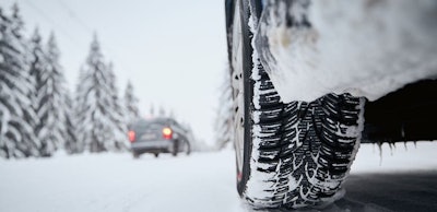 Tire of car on snow covered and icy road
