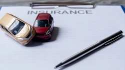 Car and pen on insurance documents. Car insurance concept