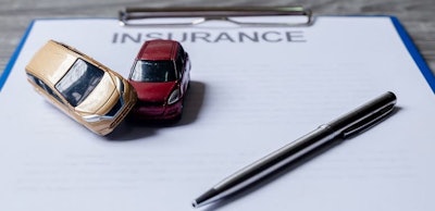 Car and pen on insurance documents. Car insurance concept
