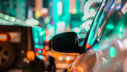 car-and-rear-view-mirror-in-city-traffic-with-ligh-2022-11-04-06-42-28-utc