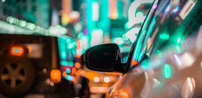 car-and-rear-view-mirror-in-city-traffic-with-ligh-2022-11-04-06-42-28-utc