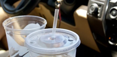 large-empty-soda-cups-in-cars-cup-holder-on-road-t-2022-11-15-12-47-53-utc