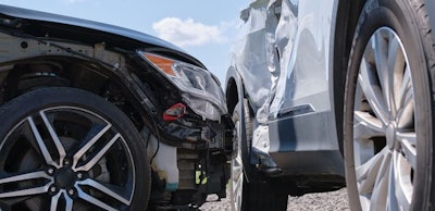 Cars crashed heavily in road accident after collision on city street. Road safety and insurance concept