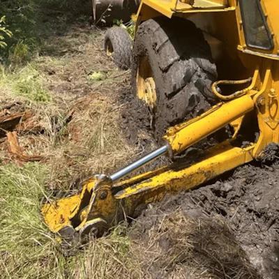 Darryl Simmons’ backhoe was down in the dirt.