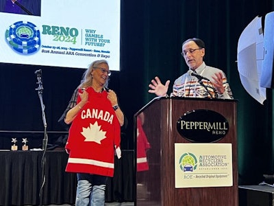 Steve Fletcher, ARC and OARA, gifts a Canada jersey to Sandy Blalock, outgoing executive director of the ARA.