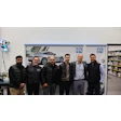 PPG team of six professionals posing in warehouse with sports car backdrop