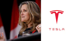 Canadian official speaking at press conference with Tesla logo