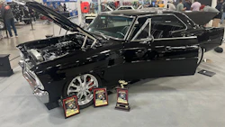 Black classic muscle car with chrome wheels and show awards at automotive exhibition