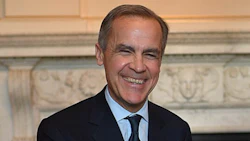 Smiling professional in dark suit against classical architectural background