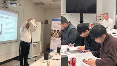 Instructor leading training session with students studying documents in classroom