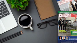 Professional workspace with laptop, coffee, notebook, and collision repair industry magazine