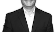 Professional smiling businessman in black suit and glasses