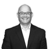 Professional smiling businessman in black suit and glasses