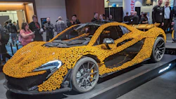 Yellow LEGO McLaren supercar sculpture at tech conference showcase