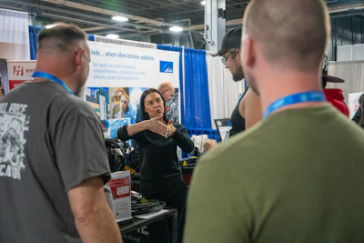 Technical presentation at industrial trade show with speaker demonstrating gas solutions