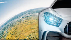 Aerial landscape meets sleek car design, blending earth's terrain with automotive innovation