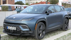 Fisker Ocean electric SUV in slate blue, parked on textured concrete