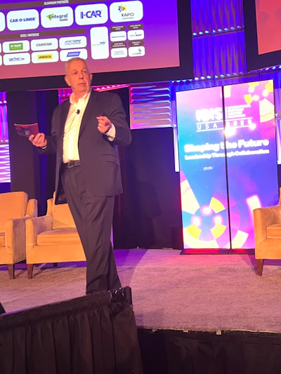 Conference speaker presenting at NACE USA event with industry partner logos backdrop