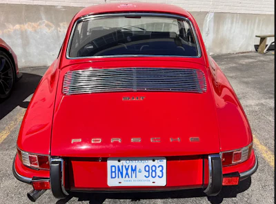 Bright red vintage Porsche 911 with classic rear styling and Ontario license plate