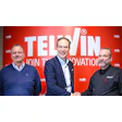 Telwin corporate team celebrating partnership with handshake against red innovation backdrop