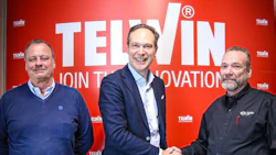 Telwin corporate team celebrating partnership with handshake against red innovation backdrop