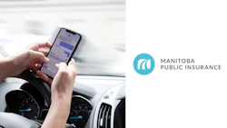 Distracted driving warning: Hand texting on smartphone while driving dashboard visible