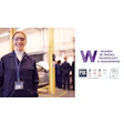 Smiling technician in safety gear at automotive workplace promoting women in technical careers