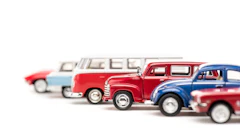 Vintage toy cars lineup featuring classic vehicles in red, blue, and white