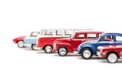 Vintage toy cars lineup featuring classic vehicles in red, blue, and white