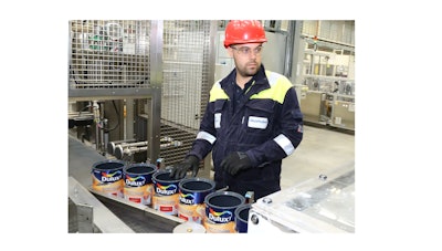 An AkzoNobel employee monitors Dulux Easycare paint production at the company's Ashington manufacturing site in the U.K.