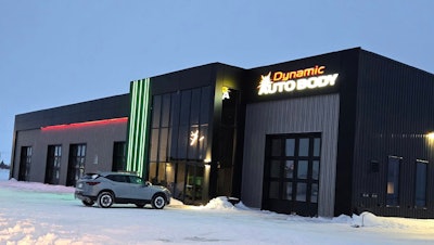 Dynamic Auto Body shop exterior with illuminated signage, gray SUV, winter snow scene