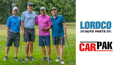 Four golfers in colorful shirts pose on green course during corporate golf event