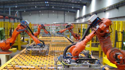 Automated manufacturing robots assembling mechanical components in industrial facility