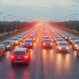 Heavy traffic with glowing red brake lights on crowded highway at dusk