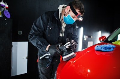 Car Detailing Concept Man Face Mask With Orbital Polisher Repair Shop Polishing Orange Suv Car