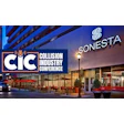 Sonesta hotel exterior at night with CIC conference branding and urban streetscape