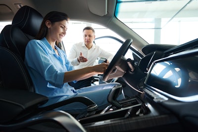 Consultant At A Car Dealership Presents A Car To C 2024 10 18 10 10 22 Utc