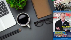 Workspace desk with laptop, coffee, trade magazine, and office accessories