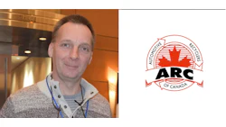 Professional at automotive conference with ARC Canada organizational logo