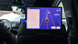 In-car touchscreen displaying autonomous driving navigation on a blue interface