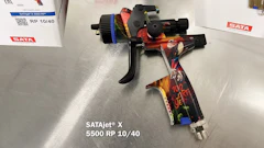 SATA professional spray gun with colorful artistic design on metallic background