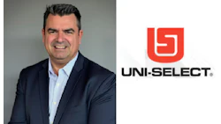 Uni-Select executive in navy blazer smiling against gray background