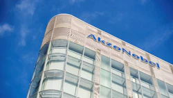 AkzoNobel corporate headquarters with curved glass and metal exterior against blue sky