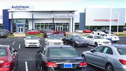 Mercedes-Benz and Porsche dealership with luxury cars parked in showroom lot
