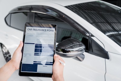Man Fills Out A Car Insurance Form After A Car Acc 2025 03 09 01 49 15 Utc